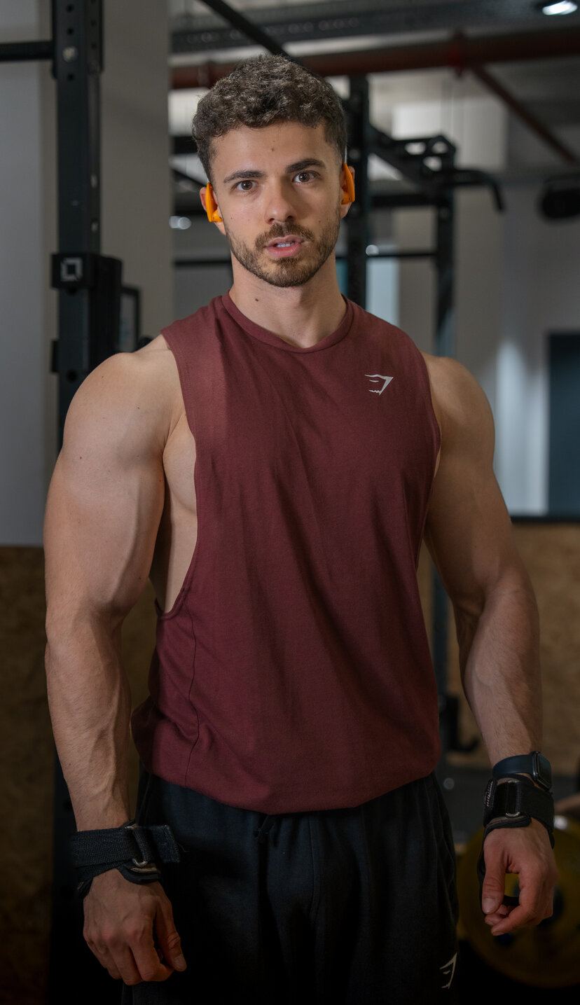 Bogdan Calinescu in a burgundy tank top, tight crop, direct gaze to camera